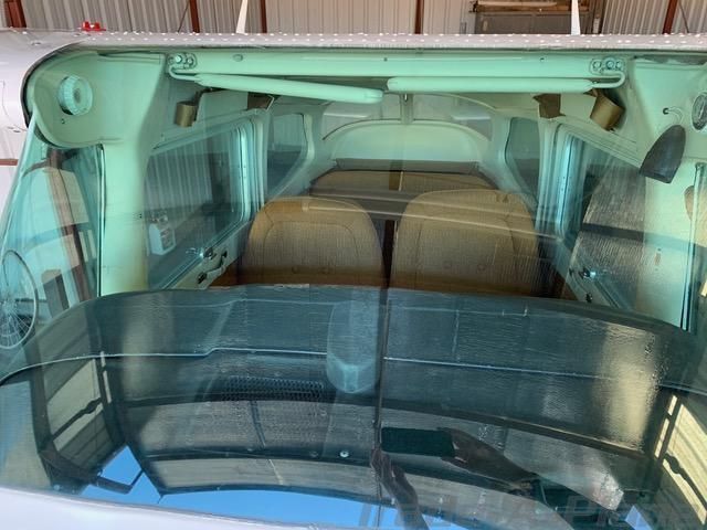 Front windshield and forward exterior view of Cessna 172N N2723E on the ramp.